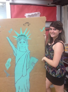 StuCo representative Diana Elliott poses with a Statue of Liberty that will be used as decoration for this year's welcome back dance.