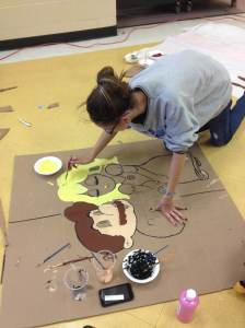 StuCo Vice President Angel Meeks paints Mario and Peach to decorate the Loving Legends Valentine's dance on Feb. 12.