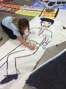 Eighth grade StuCo representative Jessica Grabowski make an Elvis Presley decoration for the Welcome Back dance Aug. 27.