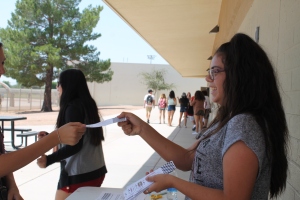 Eighth grade StuCo representative Ruby Verduzco sells a ticket to the dance. (Photo by Chloe Krueger)
